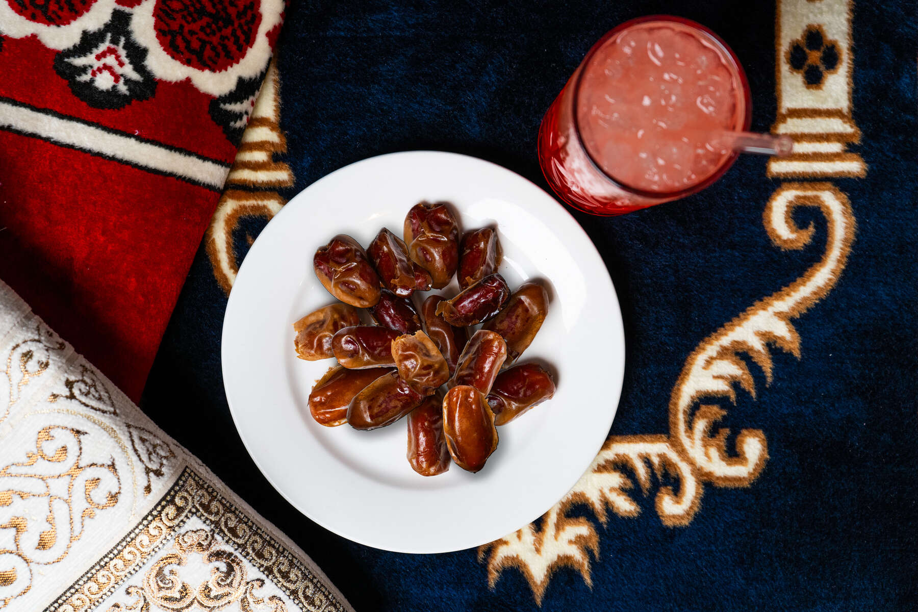 Dates on rug with drink